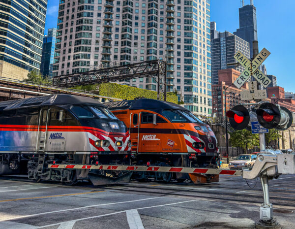 Two Metra trains running in tracks in downtown Chicago